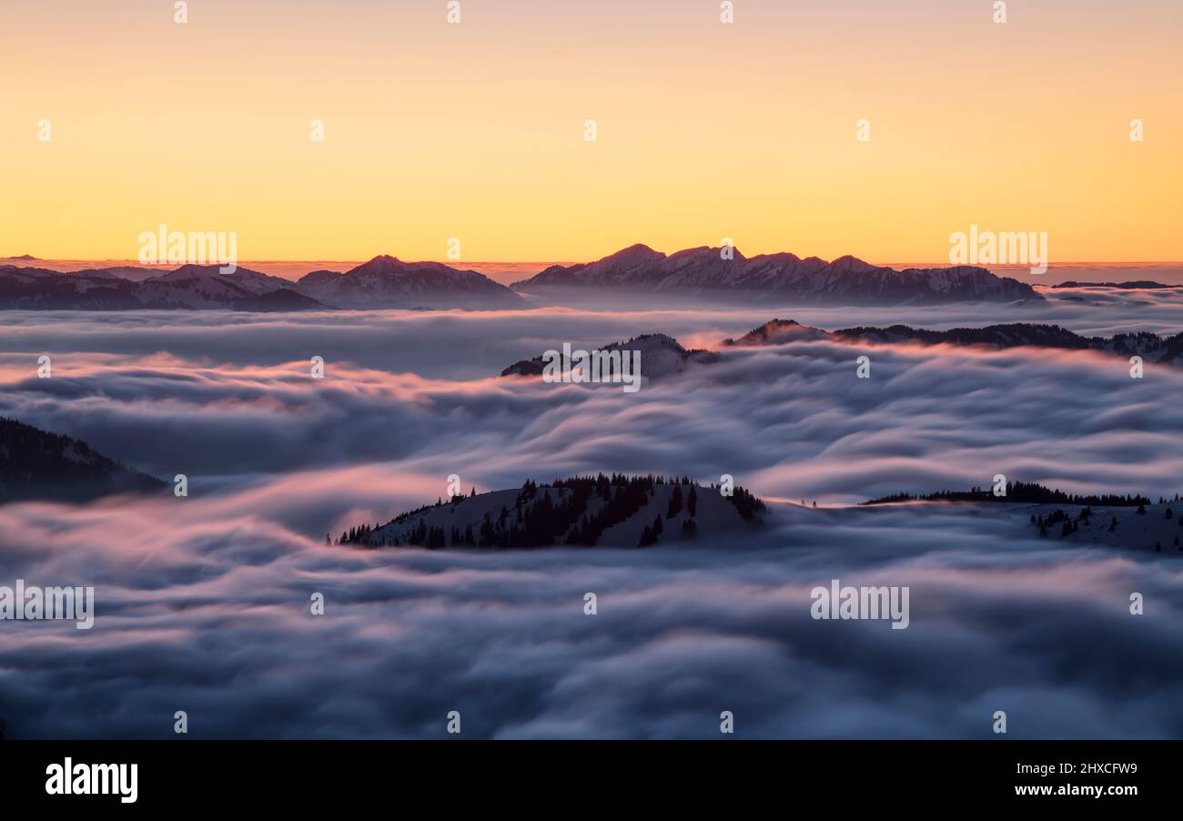 Snowy mountains after sunset over sea of fog. Hörnergruppe and Nagelfluhkette, Allgäu Alps. Bavaria, Germany, Europe Stock Photo