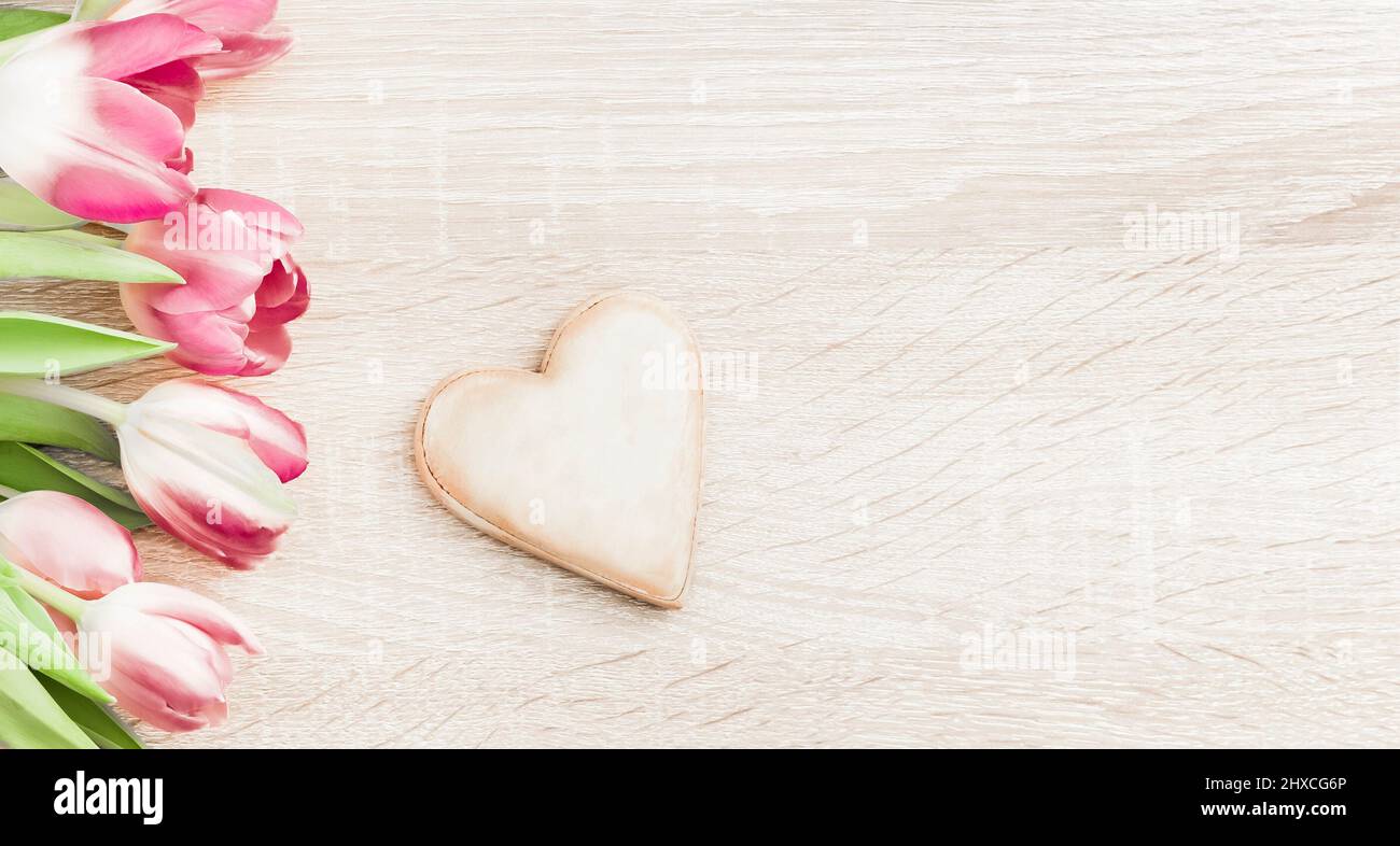 Wooden heart with pink tulips Stock Photo