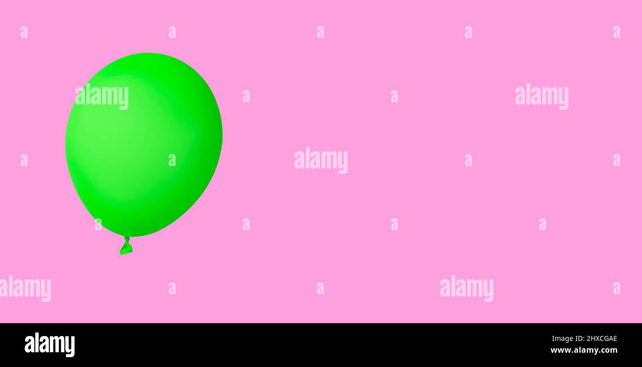 Green air balloon isolated on pink background Stock Photo