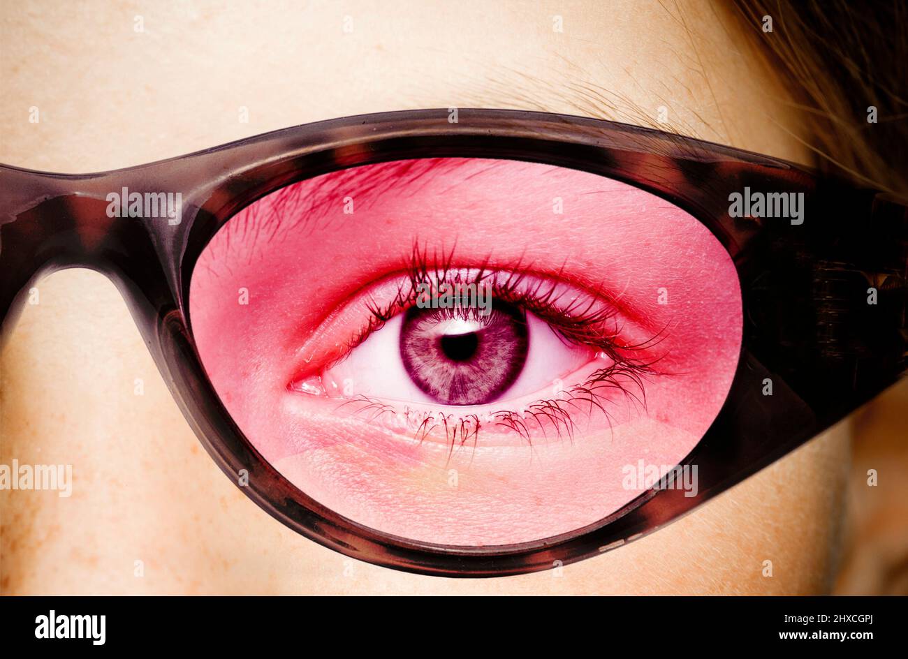 Eye with rose colored glasses Stock Photo