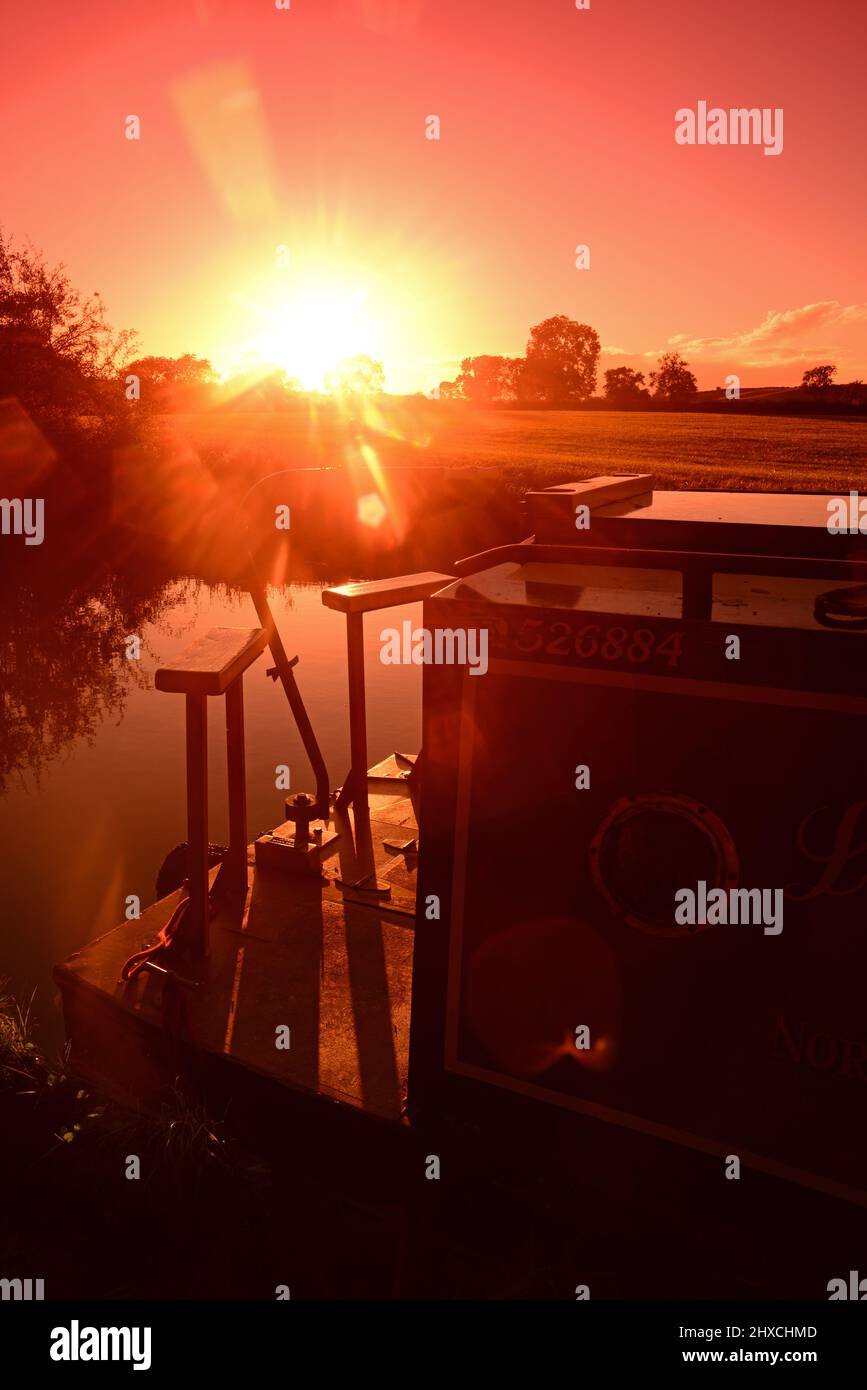 moored canal boat on the grand union canal at sunset near Theddingworth united kingdom Stock Photo