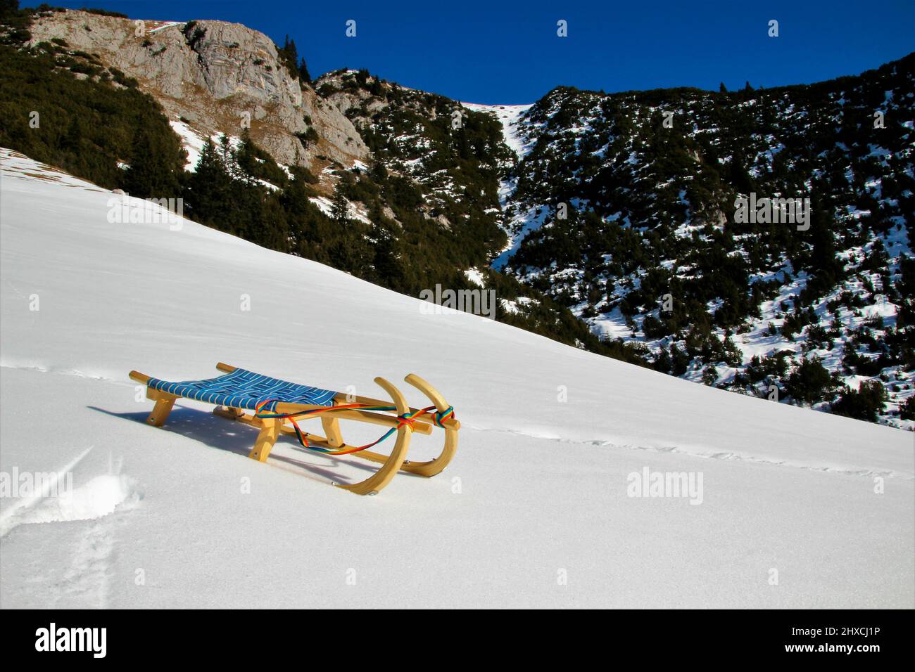 Winter hike to the Wang Alm in the Gaistal, sledges in front of a mountain backdrop in the snow, Austria, Tyrol, vacation, winter, dream weather Stock Photo