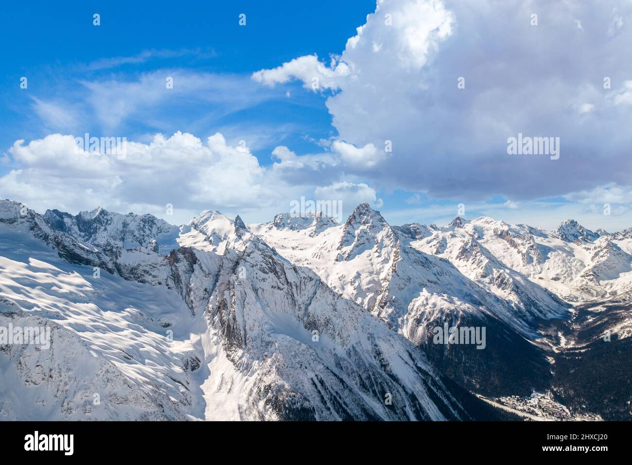 Fluffy cloud over mountains in winter  Stock Photo
