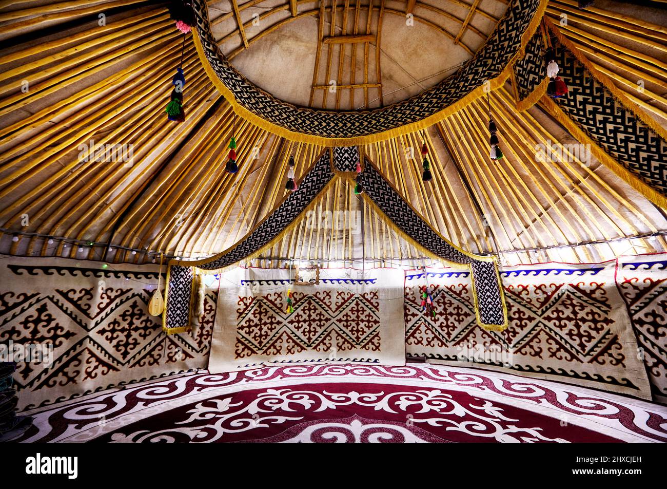 Ethnic nomadic house yurt interior with carpet and dombra instrument of national Nauryz celebration in Central Asia Stock Photo