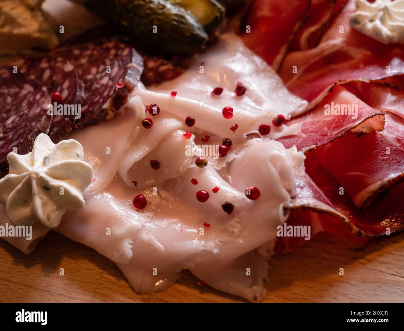Lardo Pork Fat, Speck and Salami Mixed Cold Cuts on a Board in Cortina d'Ampezzo, Italy, the Tagliere of Affetati Misti are a Speciality of the Dolomi Stock Photo
