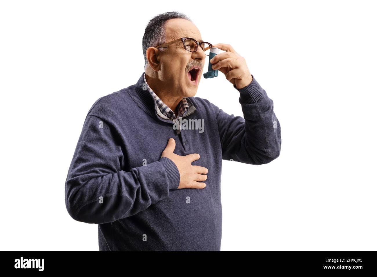 Mature man feeling unwell and using an inhaler isolated on white background Stock Photo