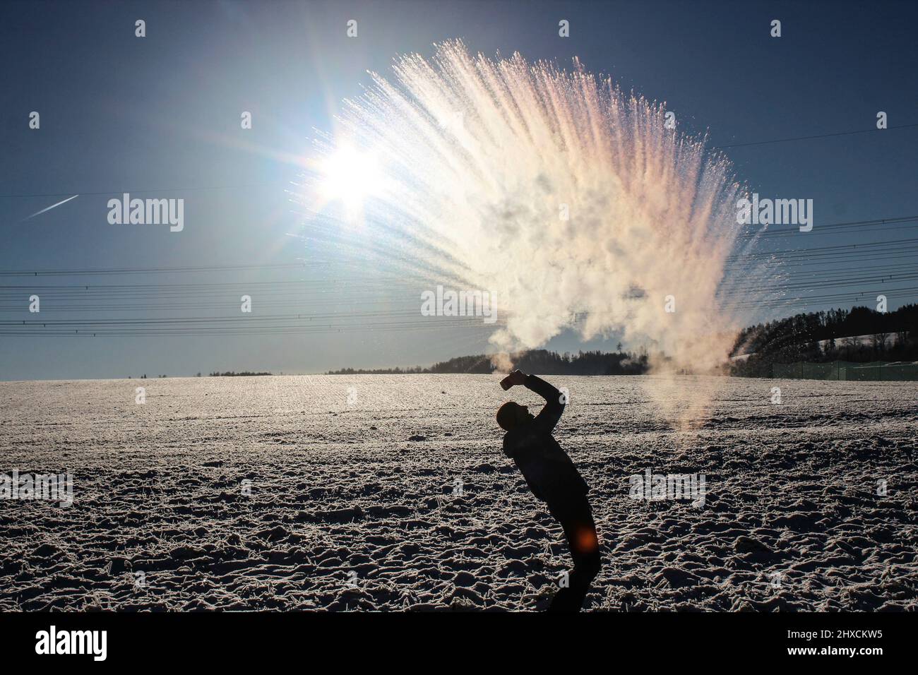 Mpemba effect, boiling water is thrown into the air at sub-zero temperatures Stock Photo