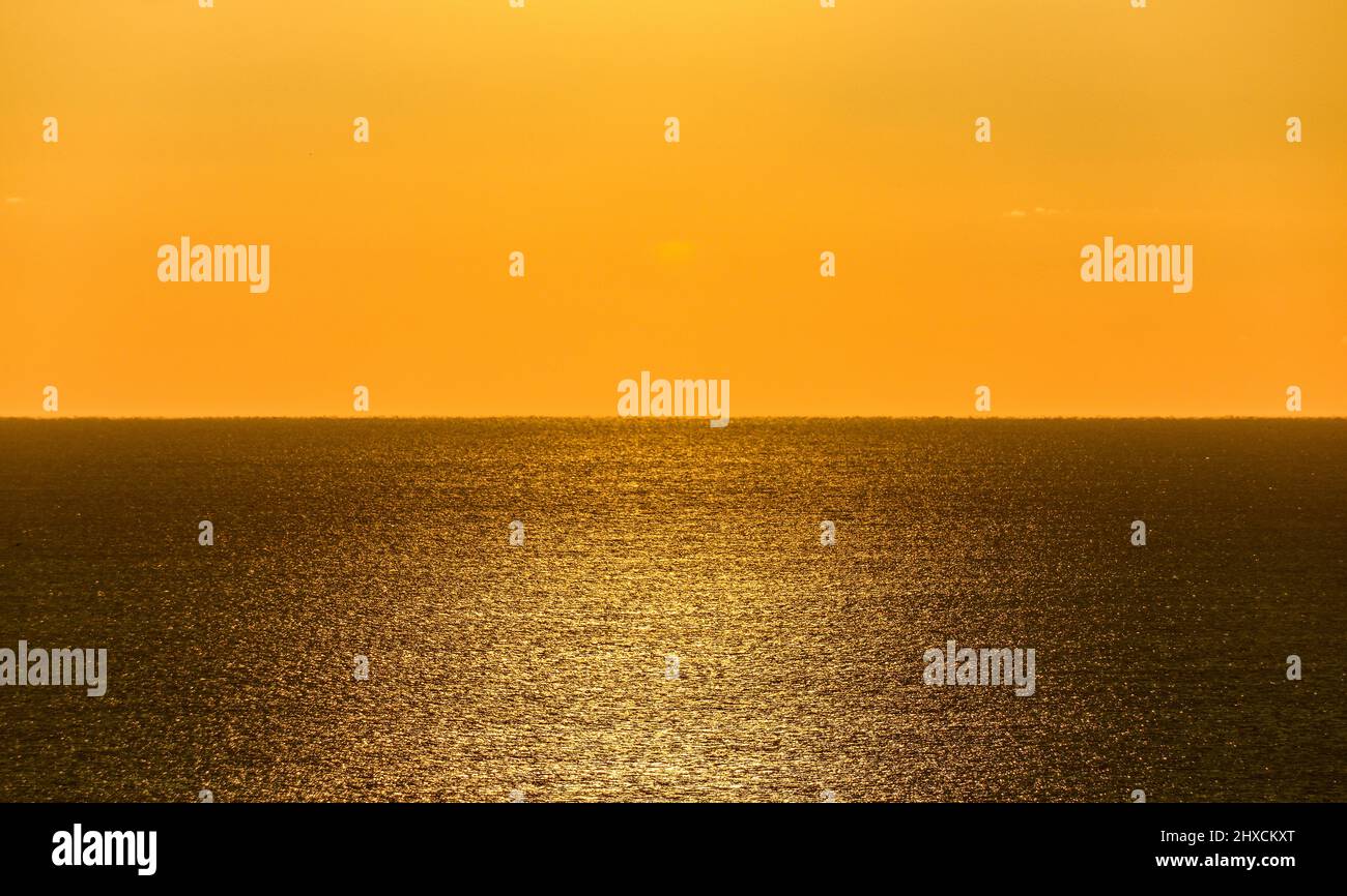 Reflection of sun rays on Atlantic Ocean, intense sky color, Algarve, Portugal Stock Photo