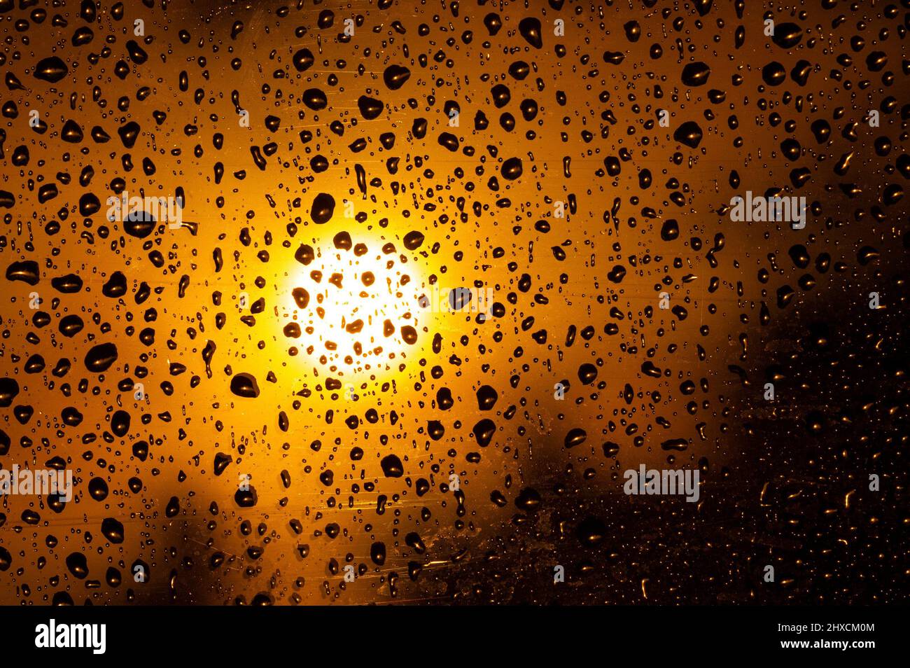 Dew drops on a window with setting sun, Killarney, Ireland Stock Photo