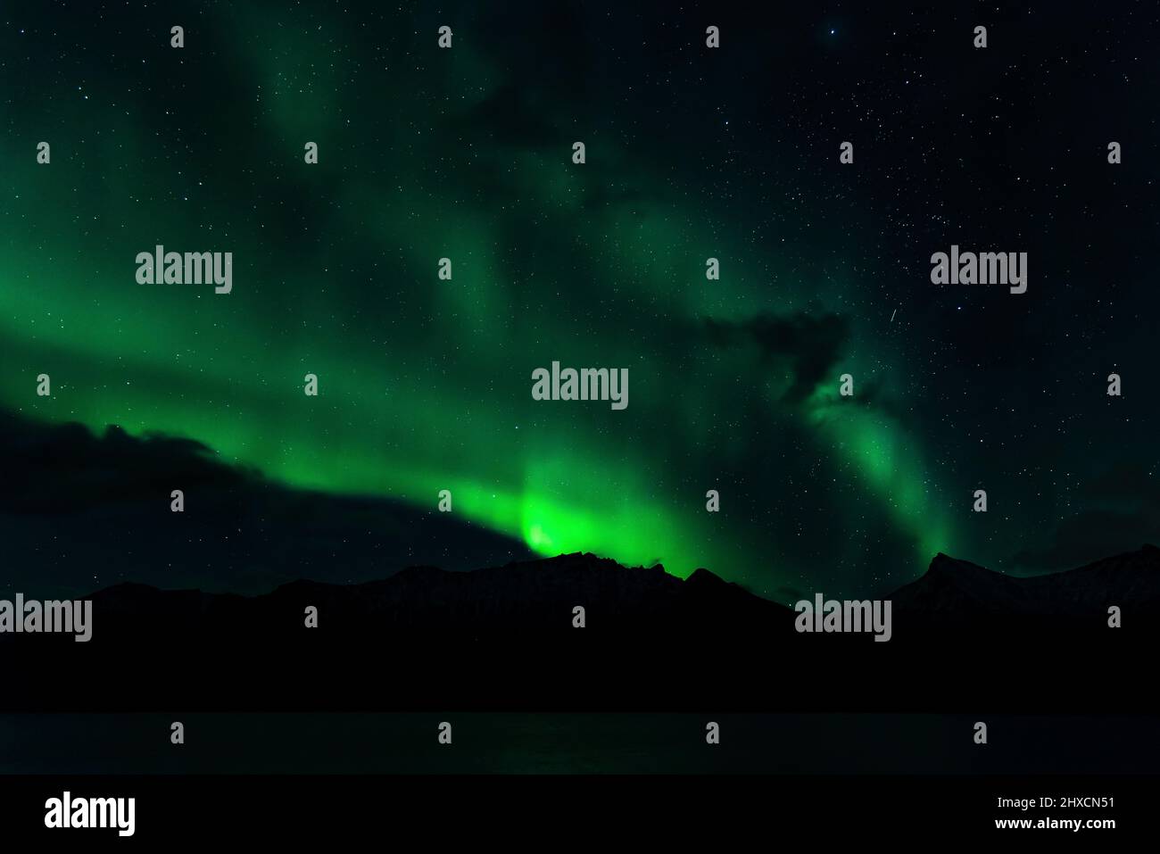 Northern Lights or Aurora Borealis dance over the fjord landscape Stock ...