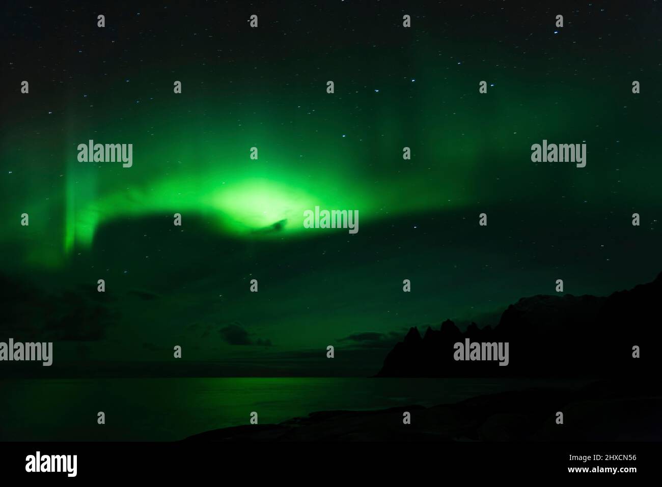 Northern Lights or Aurora Borealis dance over the fjord landscape Stock ...