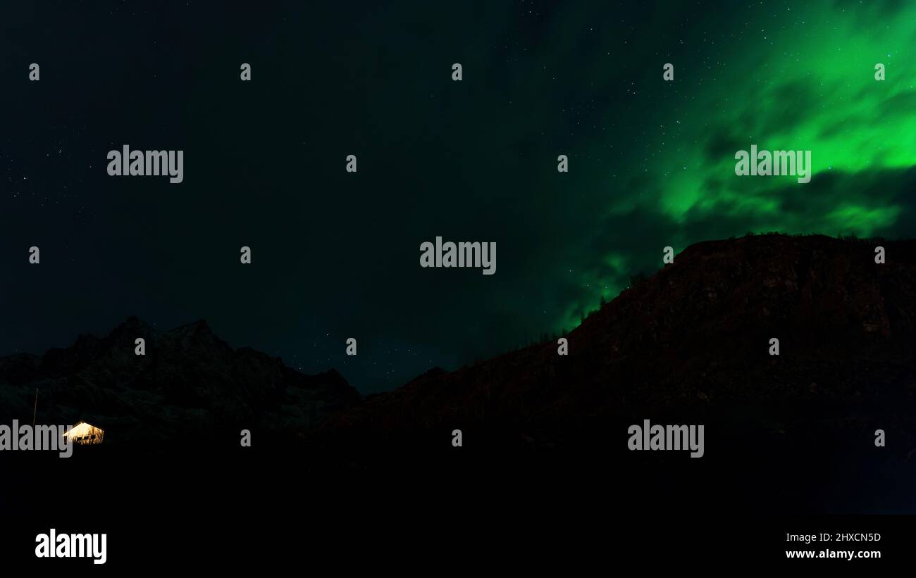 Northern Lights or Aurora Borealis dance over the fjord landscape Stock ...