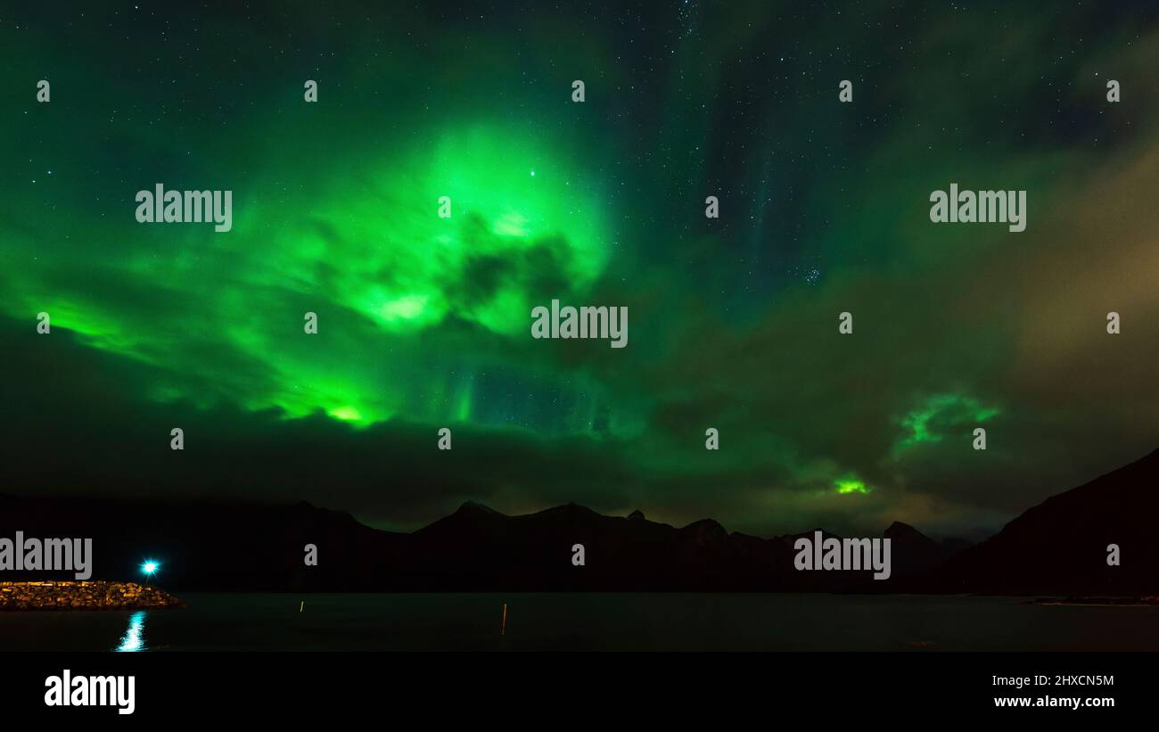 Northern Lights or Aurora Borealis dance over the fjord landscape Stock ...