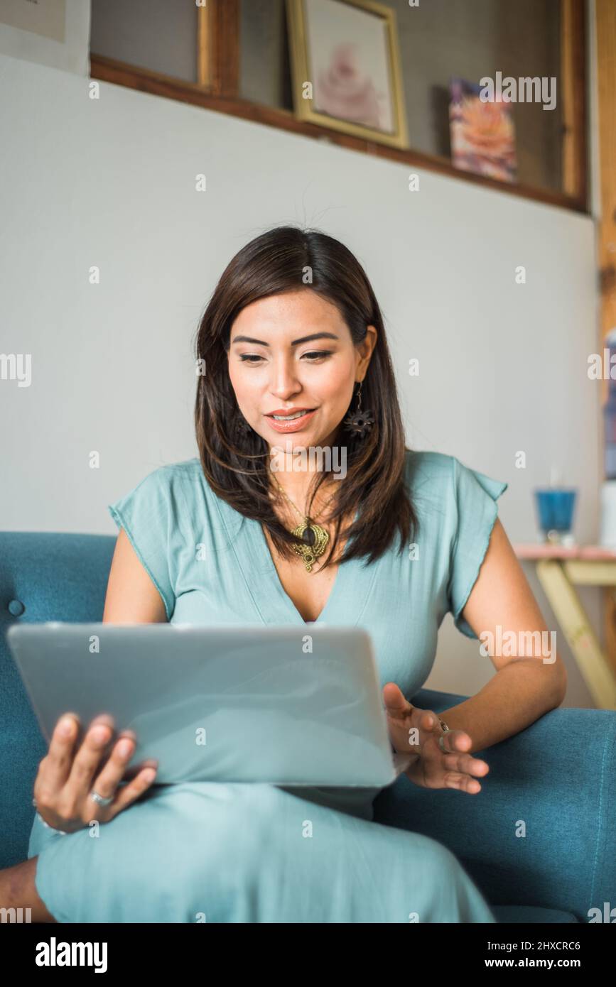 Vertical image of a woman holding a classroom in her home. Stock Photo