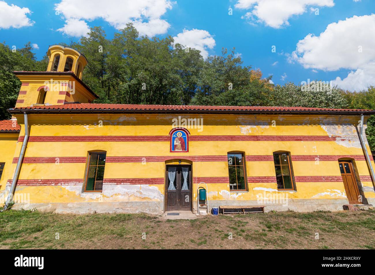 Small church in a village with beautiful blue sky and clouds in the background Stock Photo