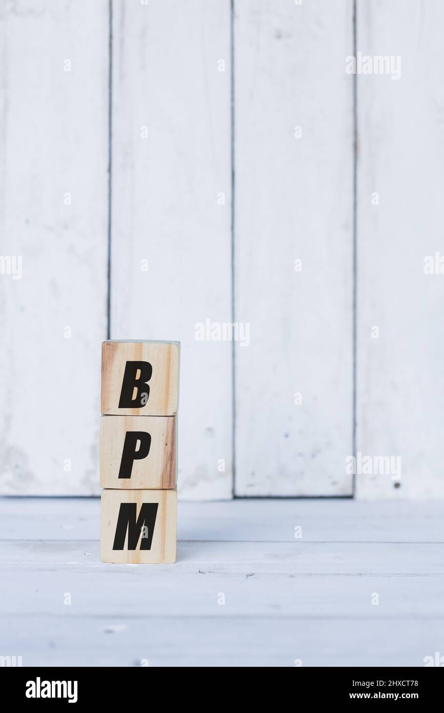 bpm concept written on wooden cubes or blocks, on white wooden background. Stock Photo