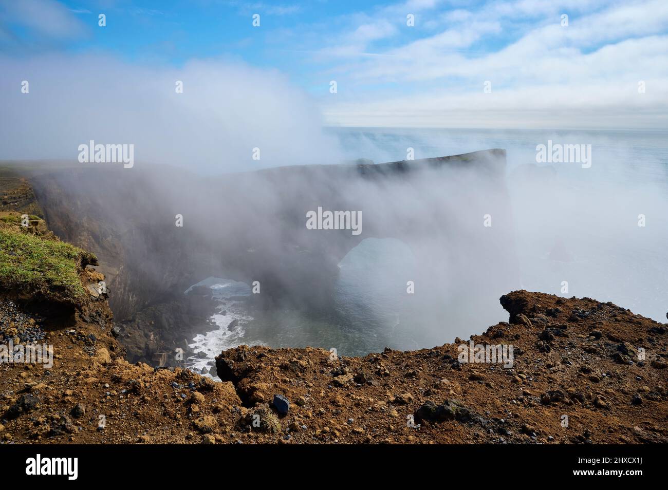 Rock arch, fog, clouds, summer, Cape Dyrholaey, Vik, Sudurland, SuÃ°urnes, Iceland Stock Photo