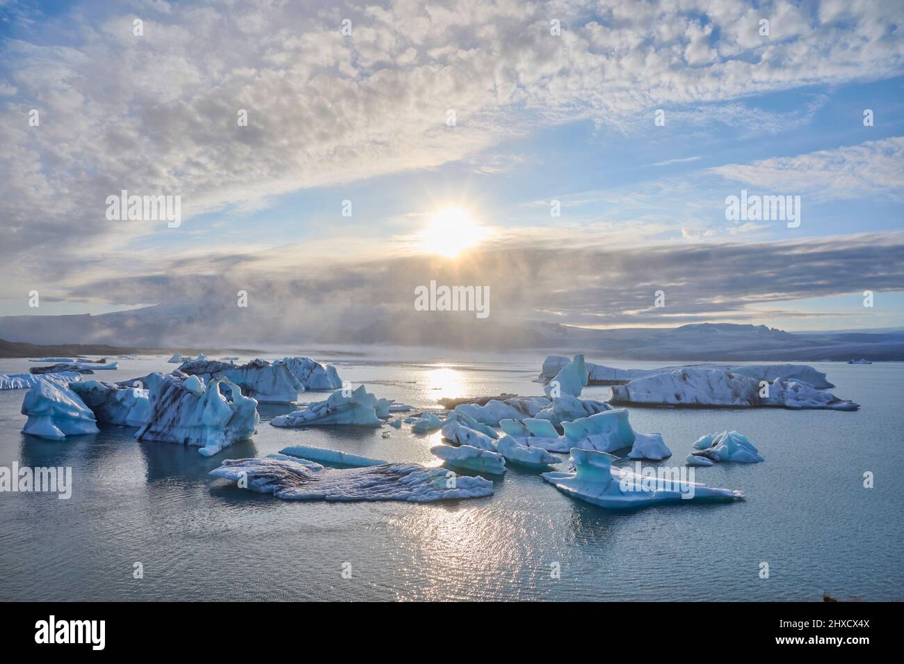 Glacier lagoon, ice, floes, fog, clouds, sun, evening, summer, Jokulsarlon, Austurland, Iceland Stock Photo