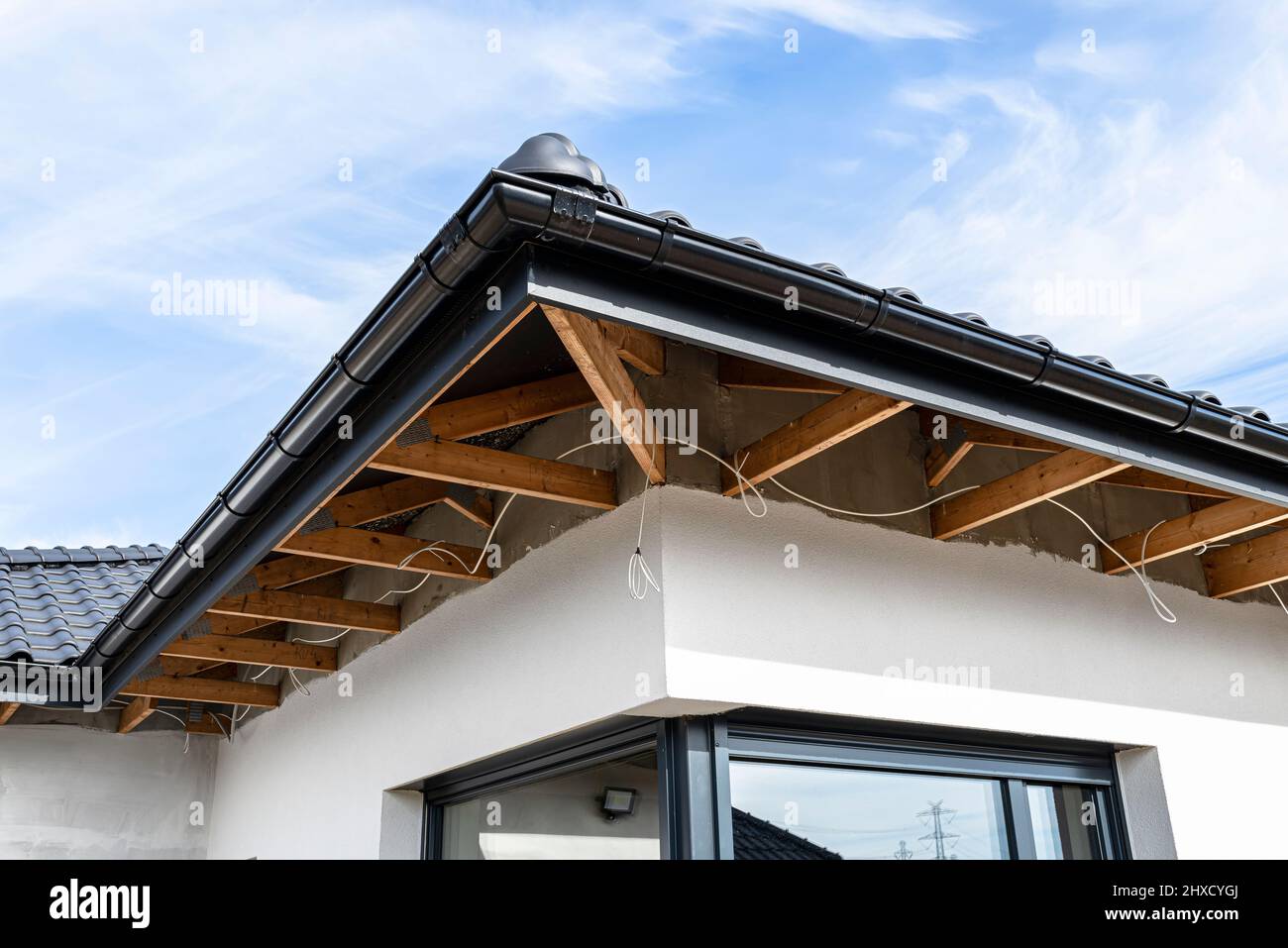 Roof trusses through which the electric cable passes to connect the lighting in the soffit Stock