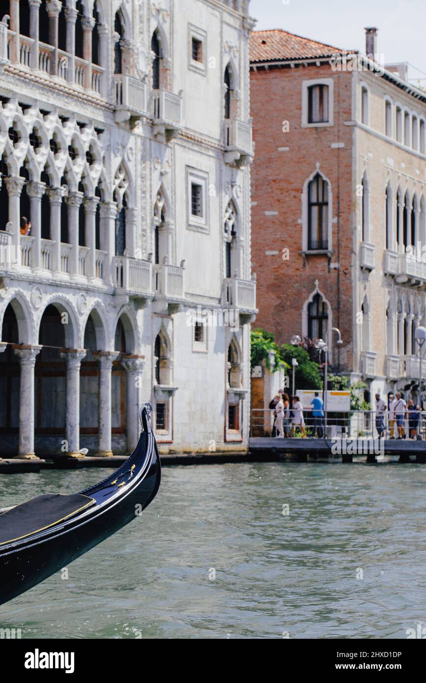 Top of a Venetian gondola in front of Palazzo Ca'd'Oro on the Grand Canal in Venice, Italy Stock Photo