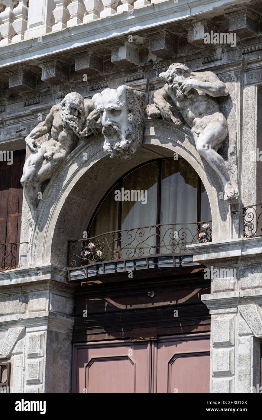 Historic stone figures over arched doorway in Santa Croce neighborhood