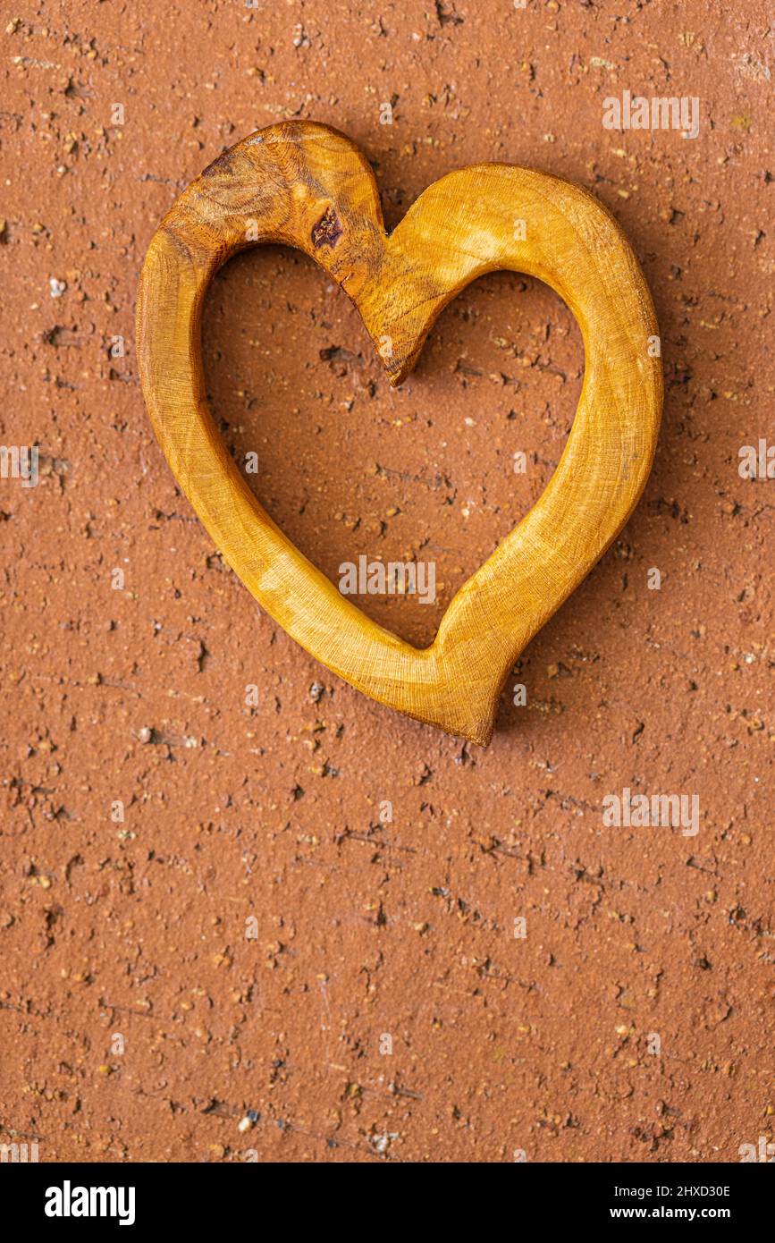 Decorative carved heart of wood, handmade, text free space below Stock Photo