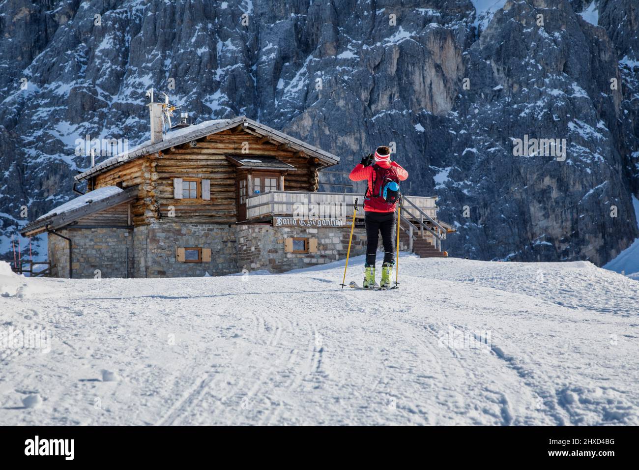 Europe, Italy, Trentino, province of Trento, natural park of Paneveggio and Pale di San Martino, woman ski mountaineer near Baita Segantini taking a picture at arrival Stock Photo