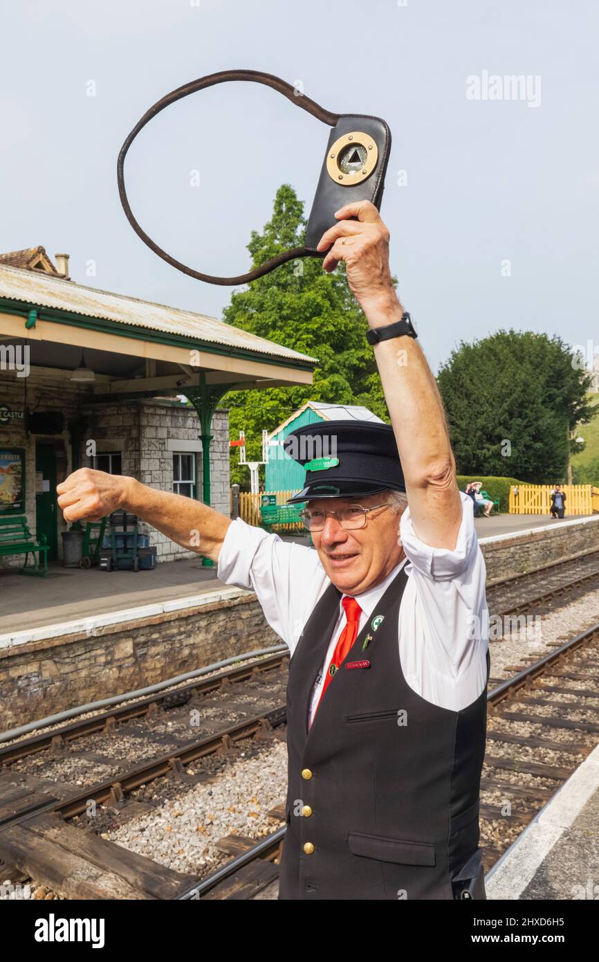 England, Dorset, Isle of Purbeck, Corfe Castle, The Historic Railway Station, Signalman Holding Exchange Pouch Containing the Key Token Stock Photo