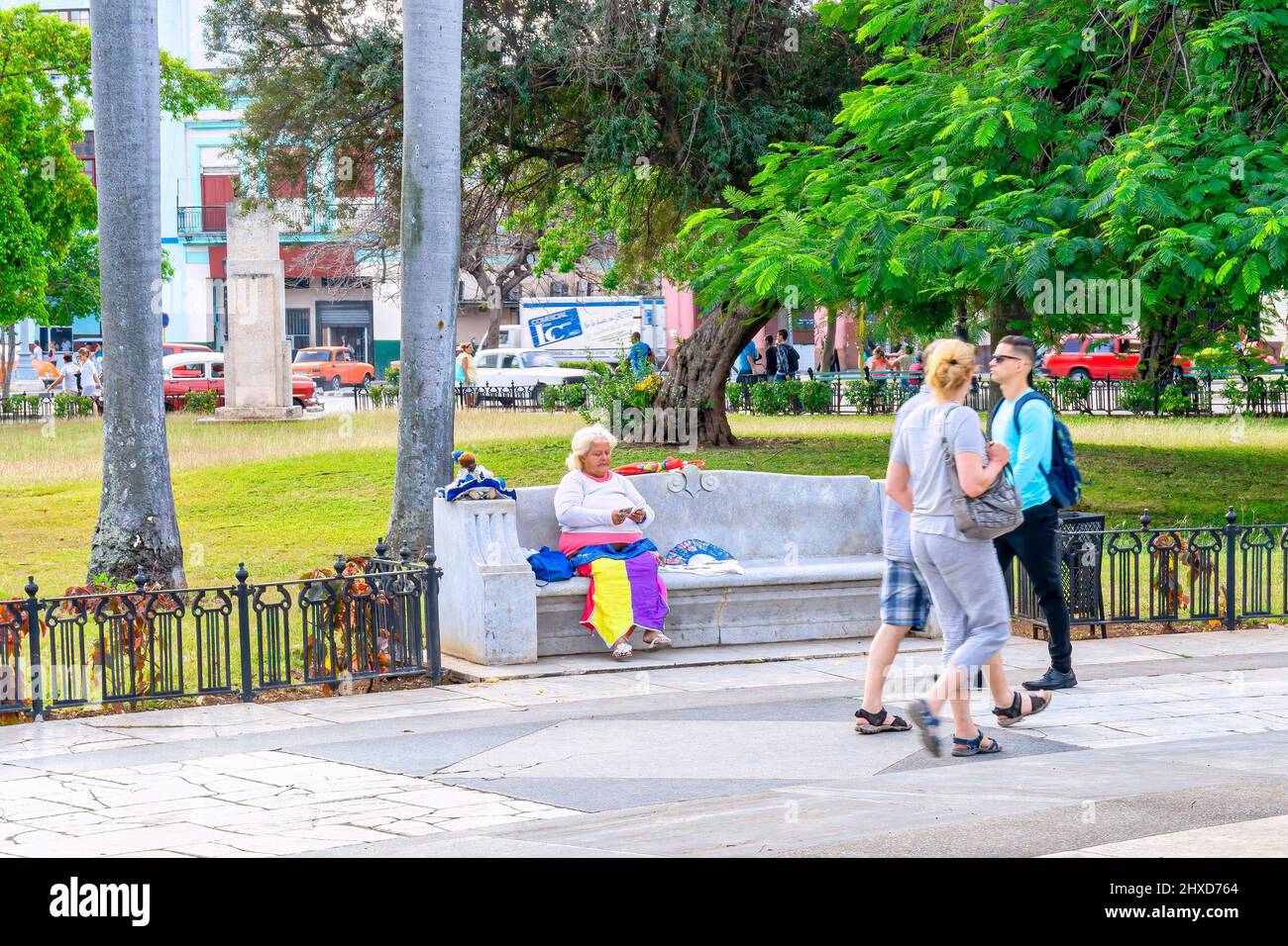 People in a square and Cuban woman reading tarot card on bench, Havana ...