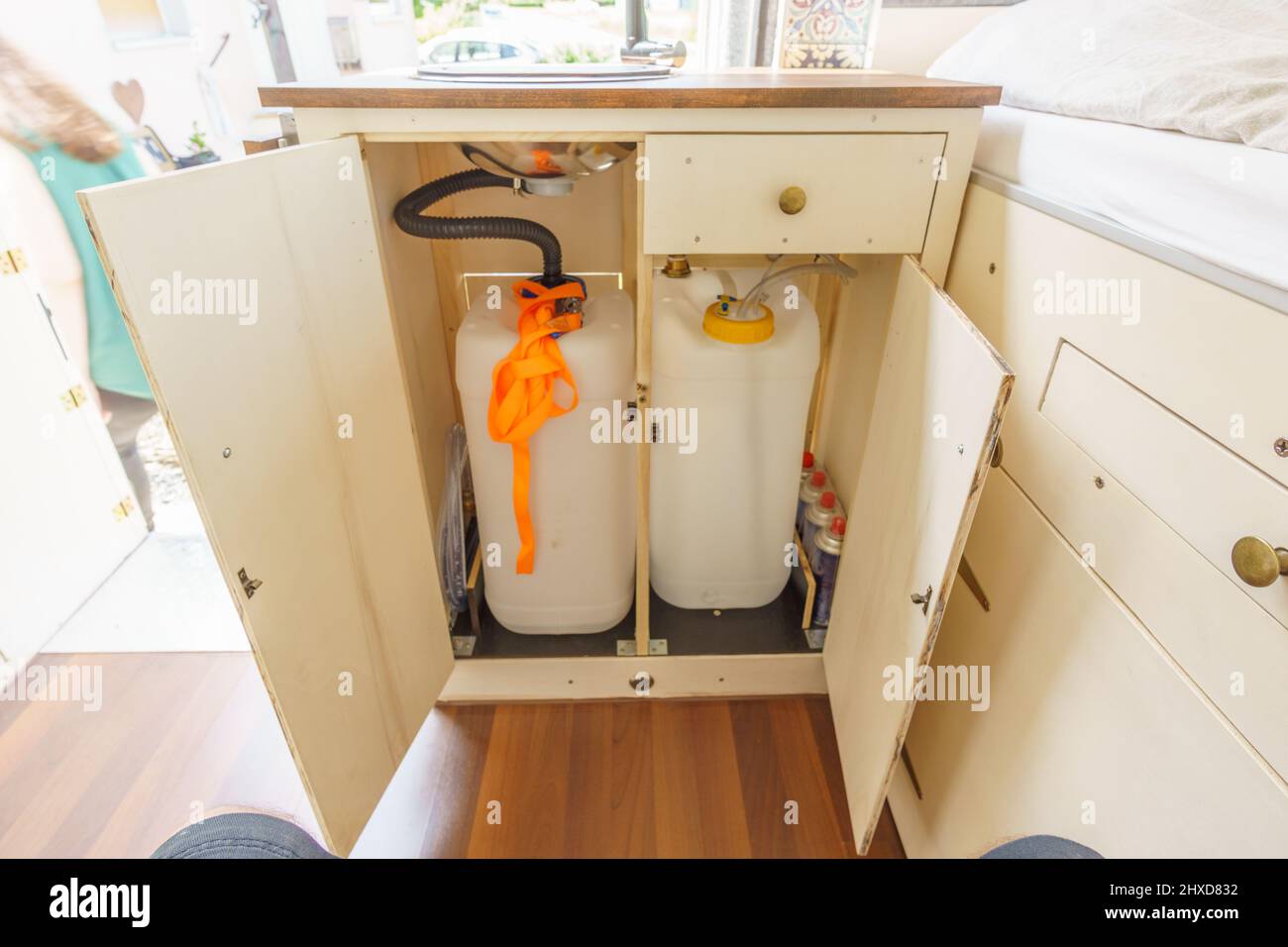 Water supply tank and waste water tank of a cupboard with a kitchen sink of a self made camper