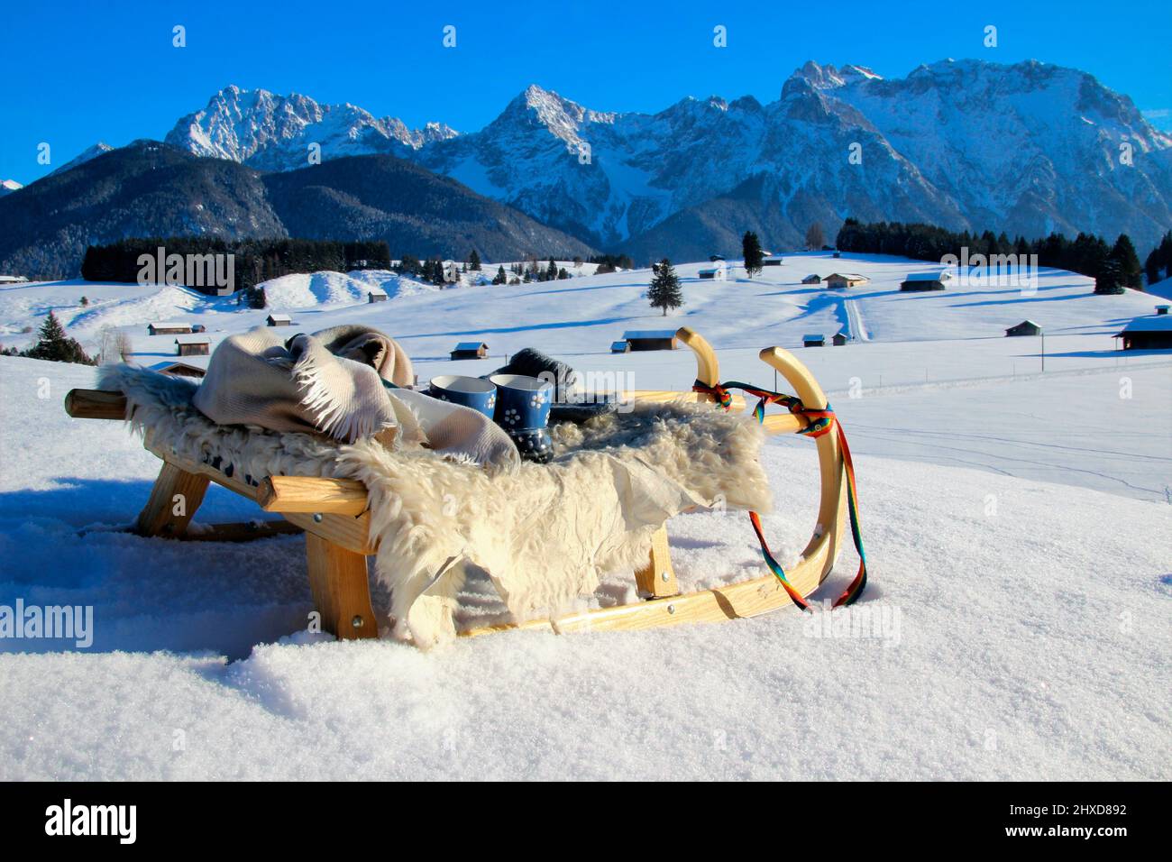 Winter hike near Mittenwald, sled with snack in front of mountain scenery in the snow, Bavaria, Upper Bavaria, Germany, vacation, winter, Stock Photo