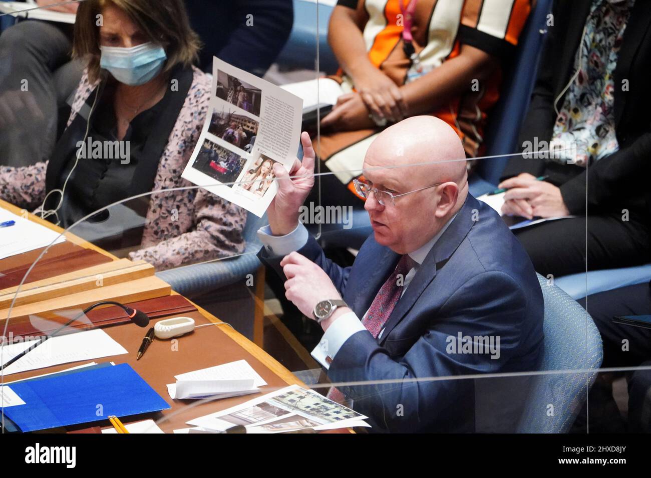 Russia's Ambassador to the U.N. Vasily Nebenzya shows pictures during the United Nations Security Council meeting on Threats to International Peace and Security, following Russia's invasion of Ukraine, in New York City, U.S. March 11, 2022. REUTERS/Carlo Allegri Stock Photo