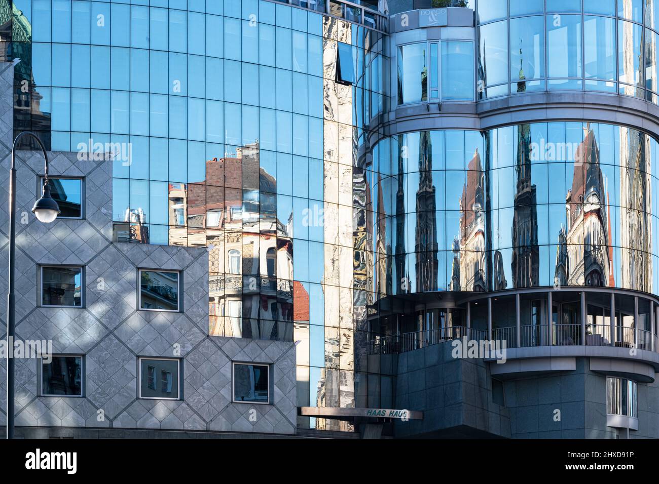 reflection of historic building in modern glass front of Haas house at Vienna's St. Stephens square Stock Photo