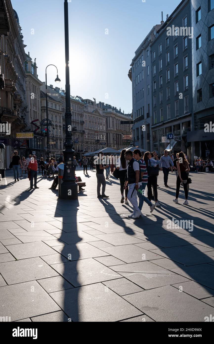 summertime late afternoon crowd and long shadows at Graben street, Vienna, Austria Stock Photo