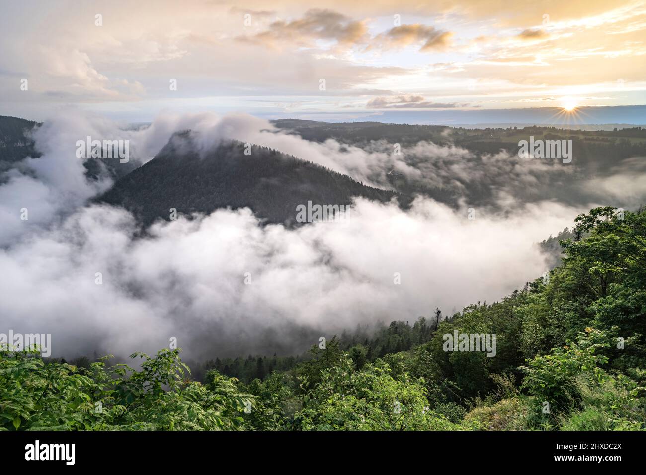 Europe, Switzerland, Canton Jura, Roches de Moron, Sea of fog over the Saut du Du's Stock Photo