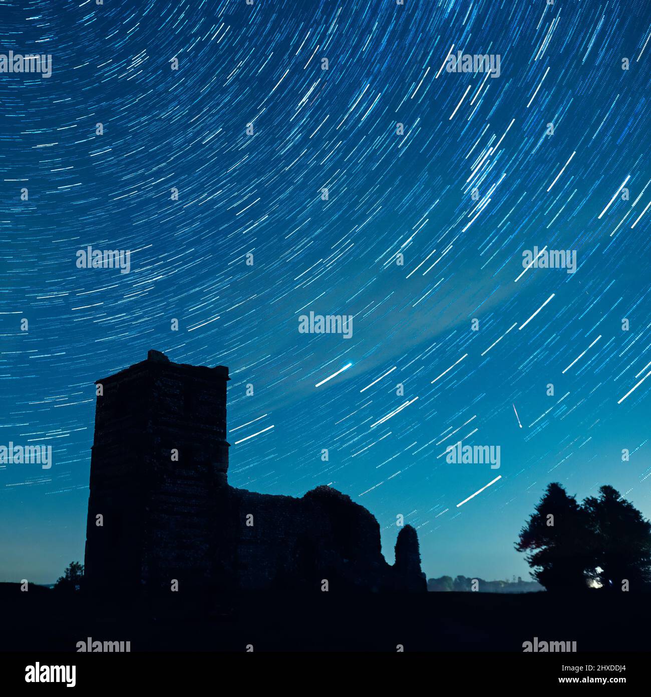 A meteor and star trails in the night sky over Knowlton Church