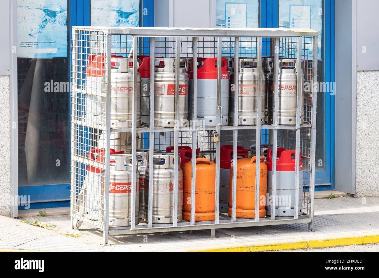 Huelva, Spain - March 10, 2022: Cepsa and Repsol gas cylinders for sale at a Service station Stock Photo