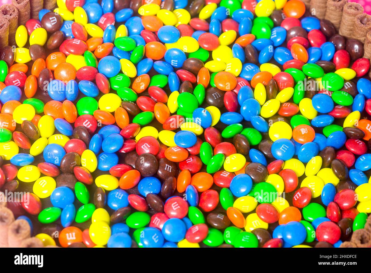 inner view of a birthday cake filled with colorful m&m and other candies Stock Photo