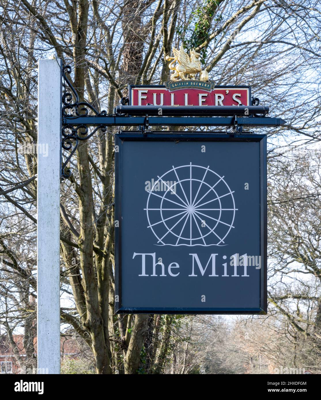 Traditional hanging pub sign at The Mill at Elstead - a Fuller's Pub and restaurant, Farnham Road, Elstead, Godalming, Surrey, England, UK Stock Photo