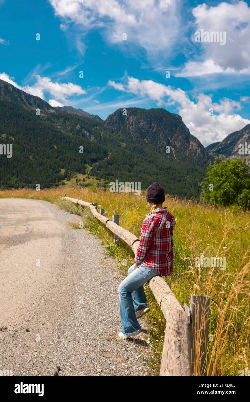 One tourist enjoy and relax in mountain scenic place. Spring and summer holiday vacation people in outdoors nature leisure activity. Blue sky and high Stock Photo
