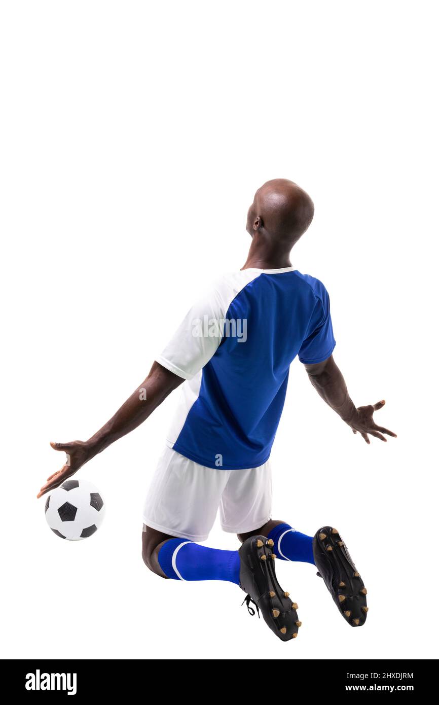 Male african american soccer player kneeling while celebrating goal on white background Stock Photo