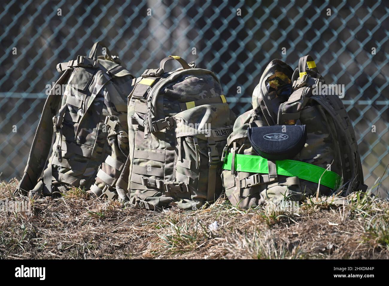 Grafenwoehr, Germany. 11th Mar 2022. Backpacks, luggage, equipment of the US soldiers lie in the grass. Prime Minister Dr. Markus Soeder visits the US military training area Grafenwoehr, headquarters of the 7th Army Training Command on March 11th, 2022. Credit: dpa picture alliance/Alamy Live News Stock Photo