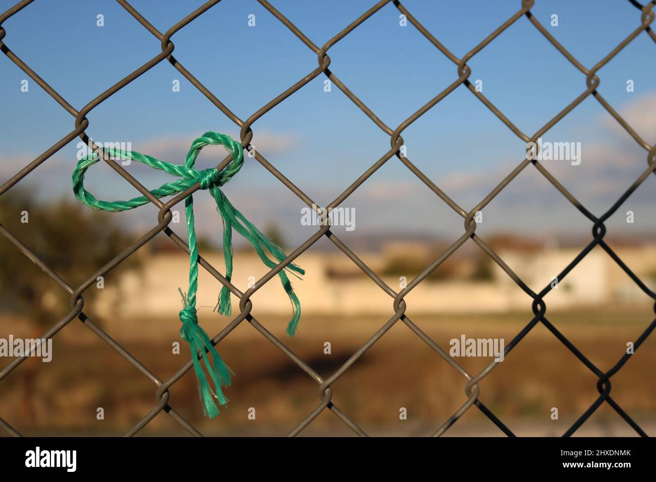 Rope symbolizing peace tied to wire mesh Stock Photo