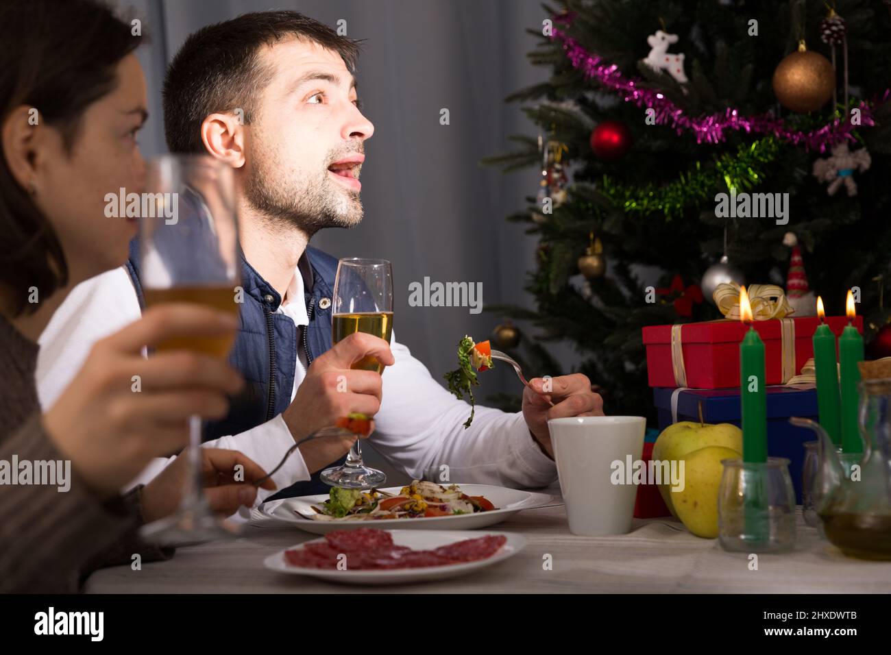 Couple having christmas dinner and watching tv Stock Photo
