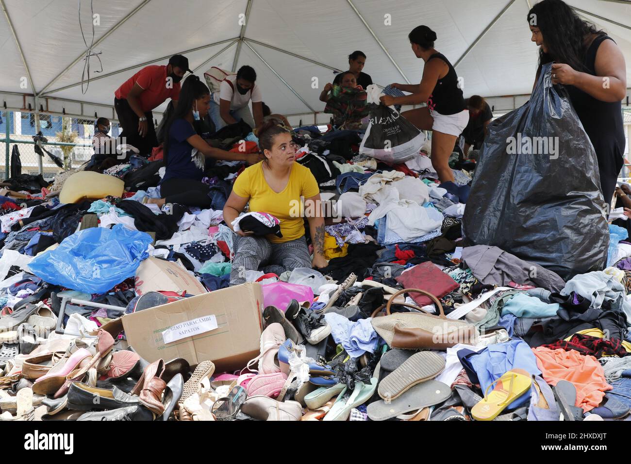 Homeless people collect clothes from donations. Victims of natural