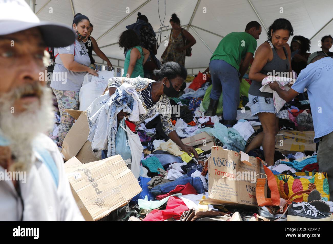 Homeless people collect clothes from donations. Victims of natural
