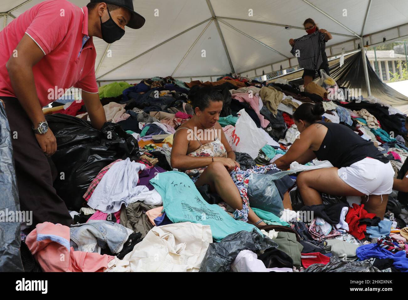 Homeless people collect clothes from donations. Victims of natural