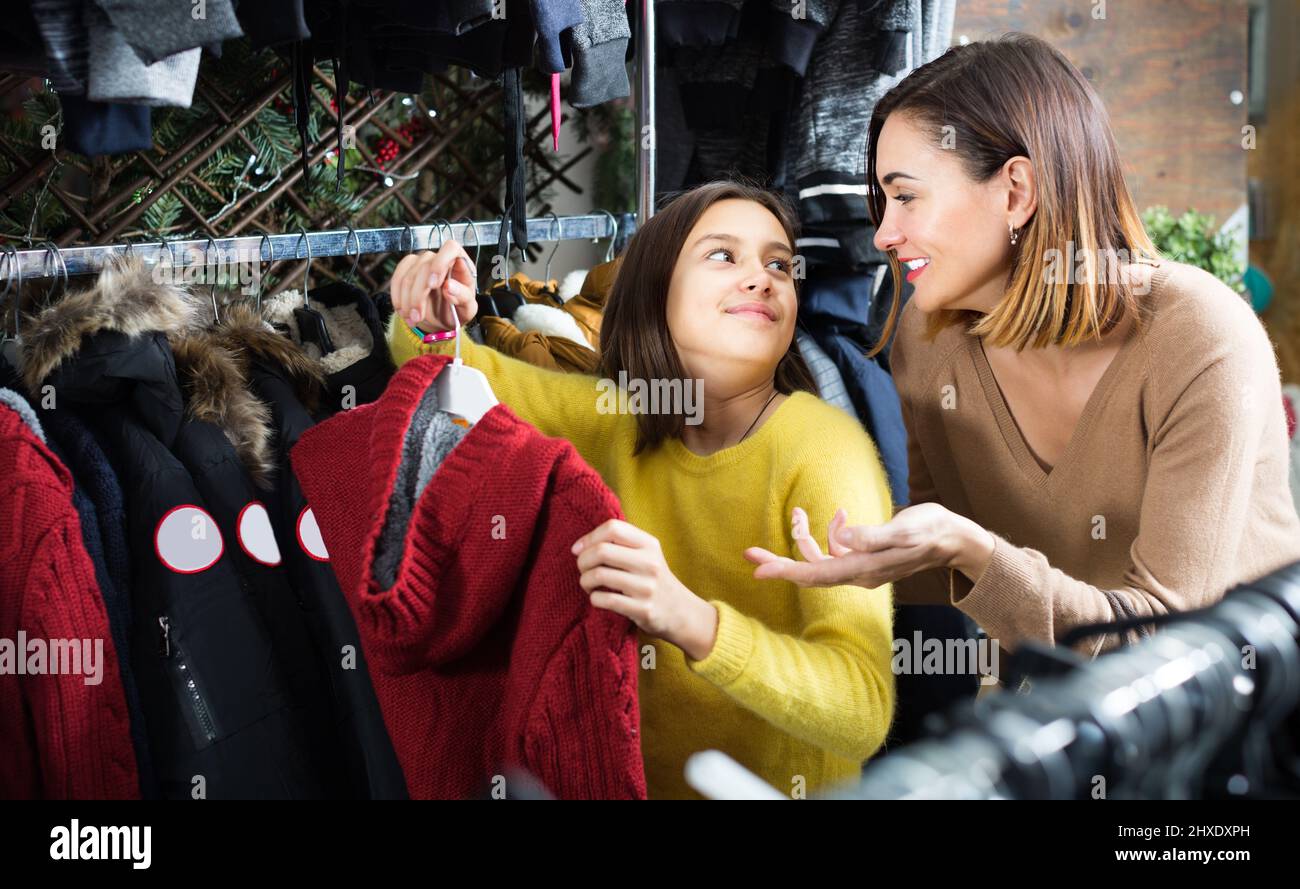 Woman and girl buying warm sweater in store Stock Photo Alamy