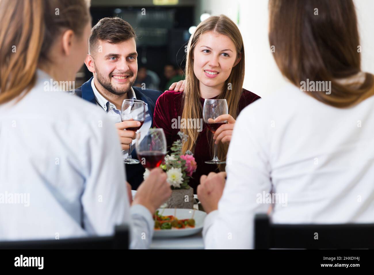 Gentleman with elegant women are having dinner in luxury restaurante Stock Photo