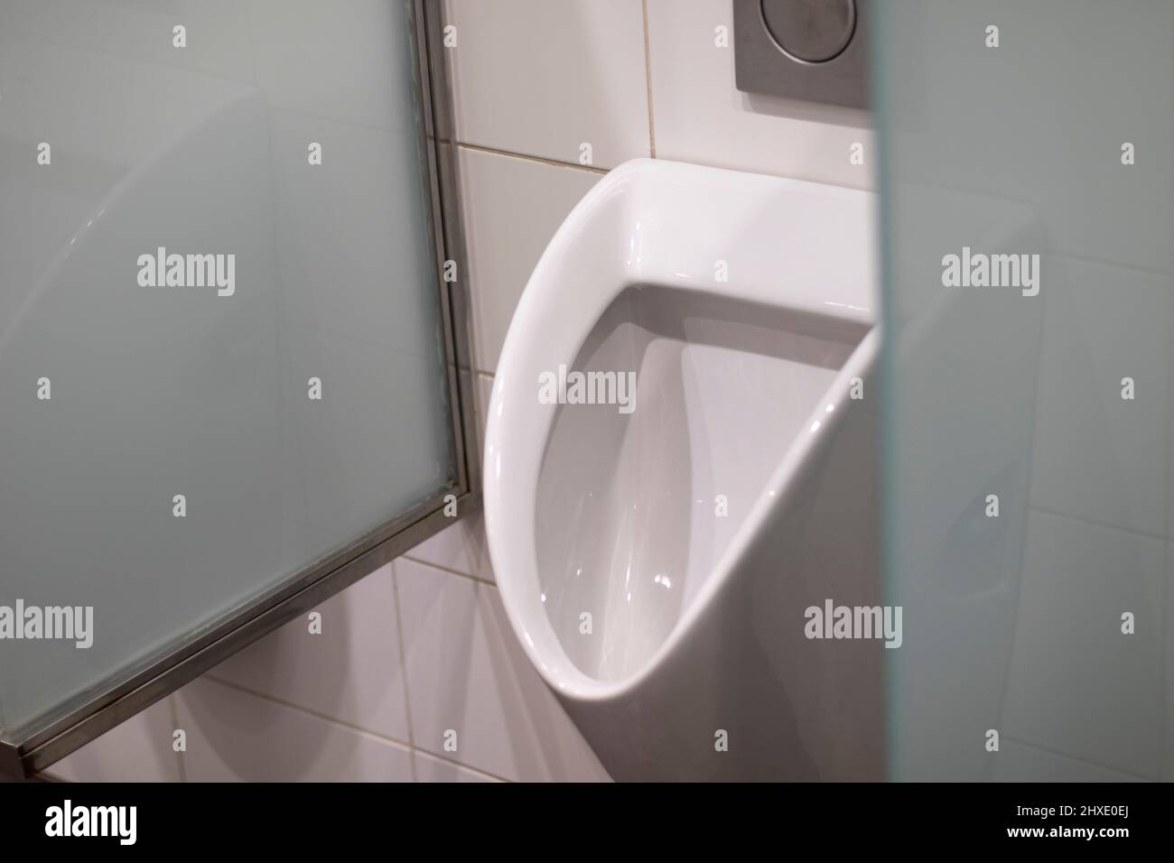 Public porcelain urinal for men, with glass partitions Stock Photo Alamy